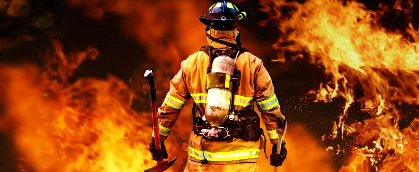 Bombero interviniendo entre las llamas de un incendio en una vivienda